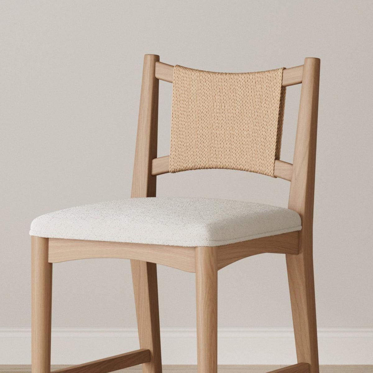 A wooden chair with a white upholstered seat and a woven backrest.