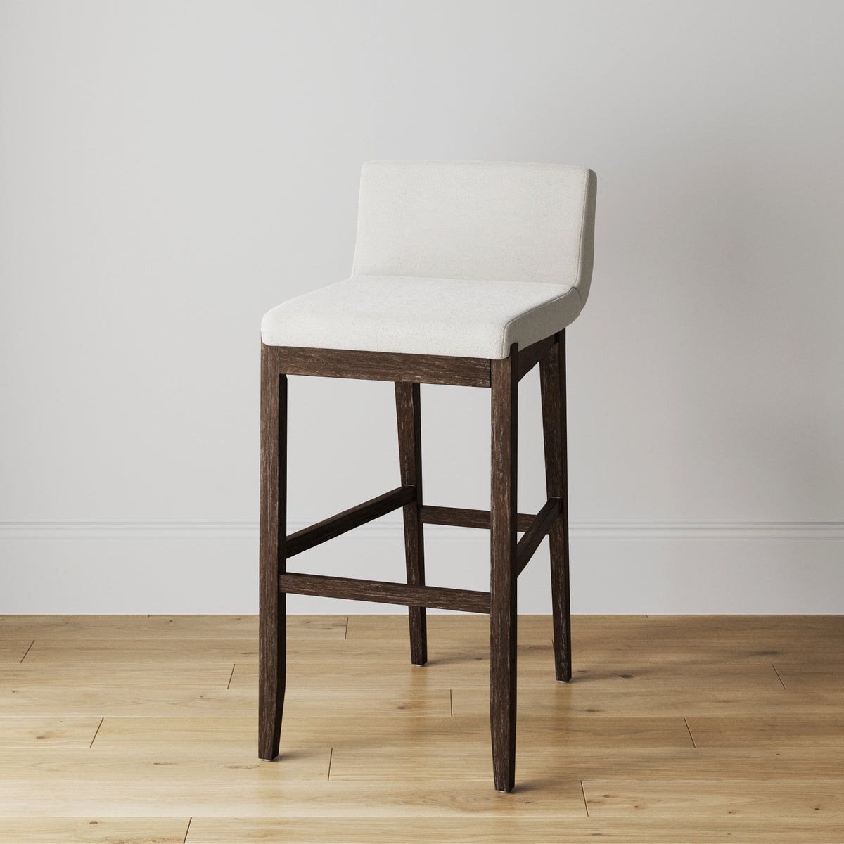 Bar stool with dark wood legs and an upholstered white seat and backrest.