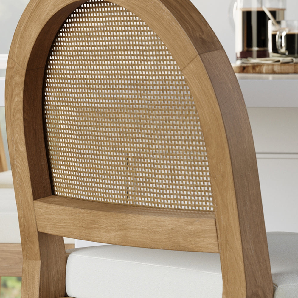 Wooden dining chair with an arched back and woven cane paneling.