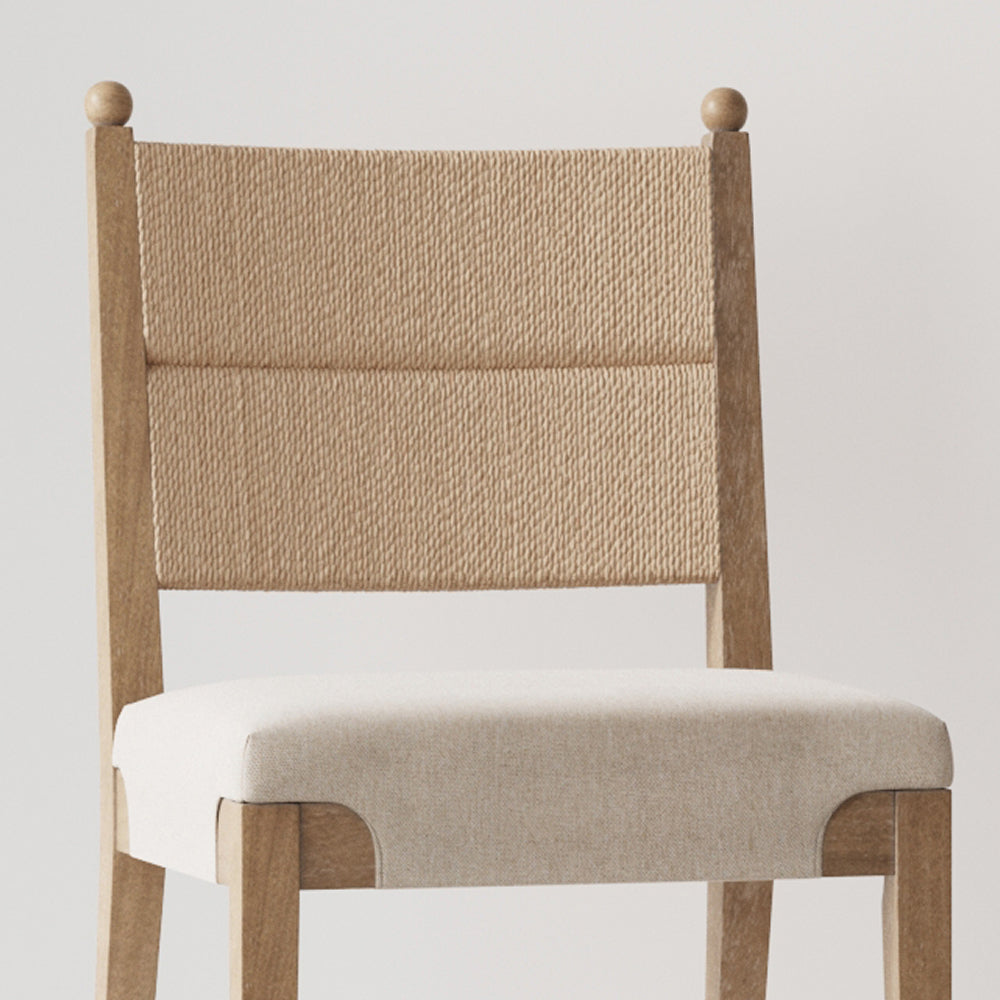 Wooden dining chair with a woven rope backrest and an upholstered seat.