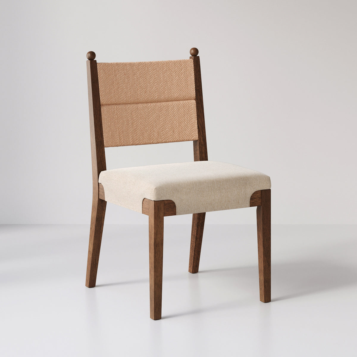 Wooden dining chair with a light beige upholstered seat and a woven backrest featuring ball-topped side posts.