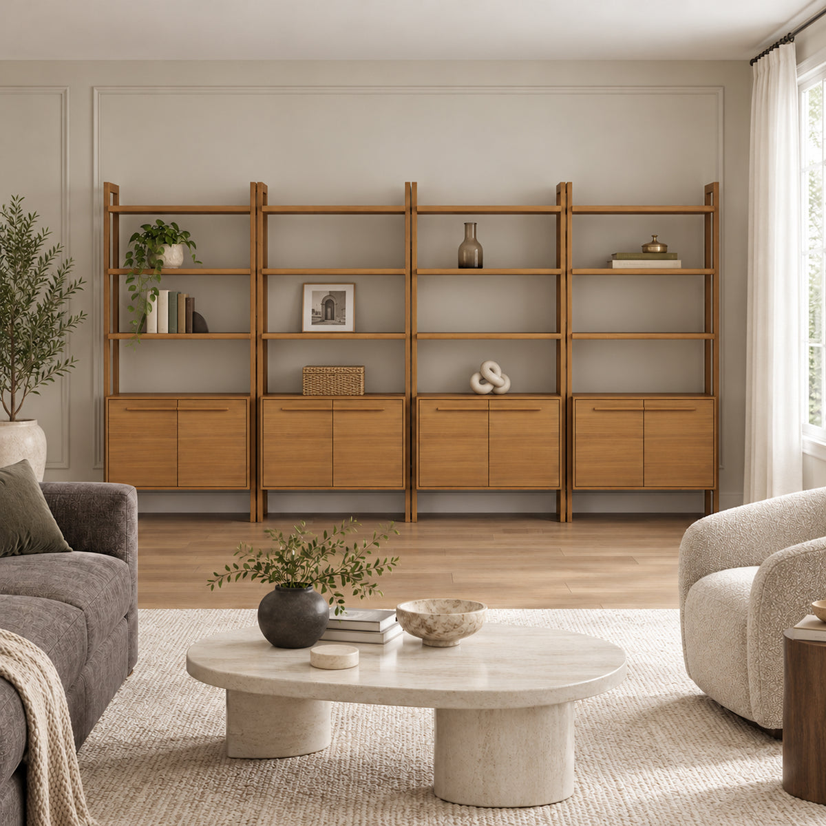 A living room featuring a long, four-section wooden wall unit with open shelving and cabinet bases, situated behind a round stone coffee table and seating.