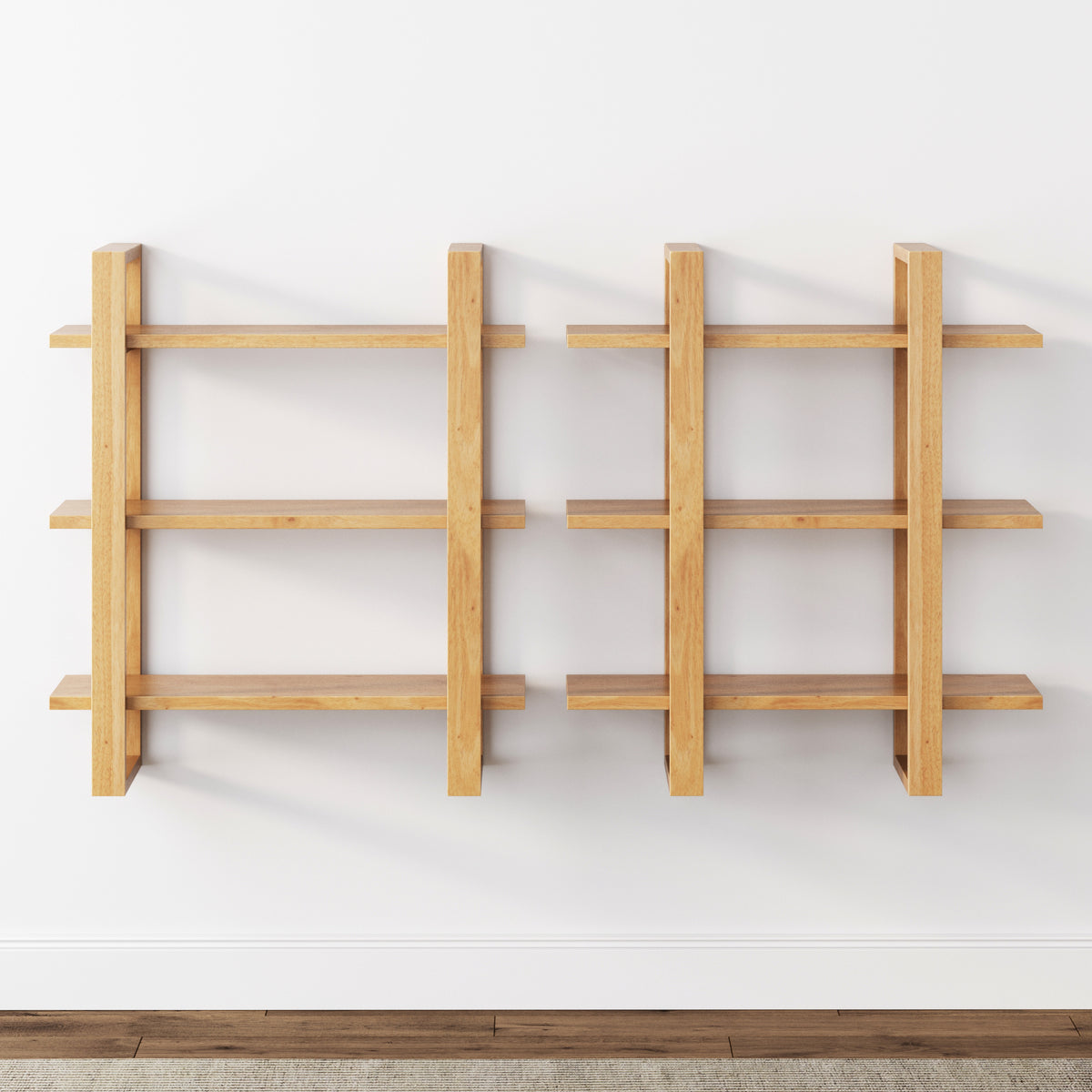 Two wooden wall-mounted shelves with three horizontal shelves each, arranged side by side against a white wall above a wooden floor. The shelves have a modern, minimalist design.