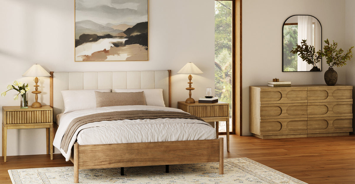 A modern bedroom featuring a wood bed frame with an upholstered headboard, two matching nightstands with lamps, and a wooden dresser with a mirror.