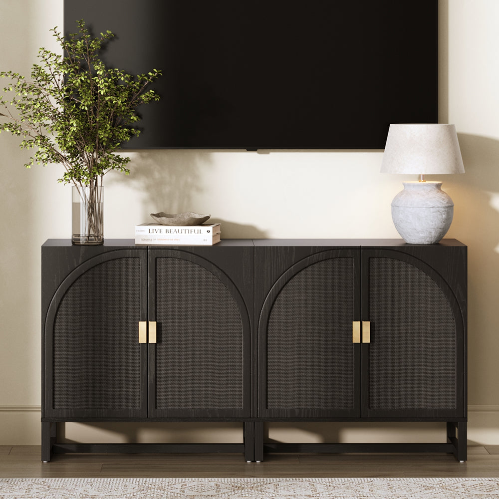 Black media console with four doors featuring arched cane detailing and gold handles, topped with a vase of greenery, a book, and a lamp beneath a wall-mounted television.