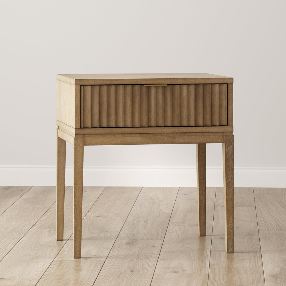 Light wood nightstand with a single fluted drawer and a thin metal handle.