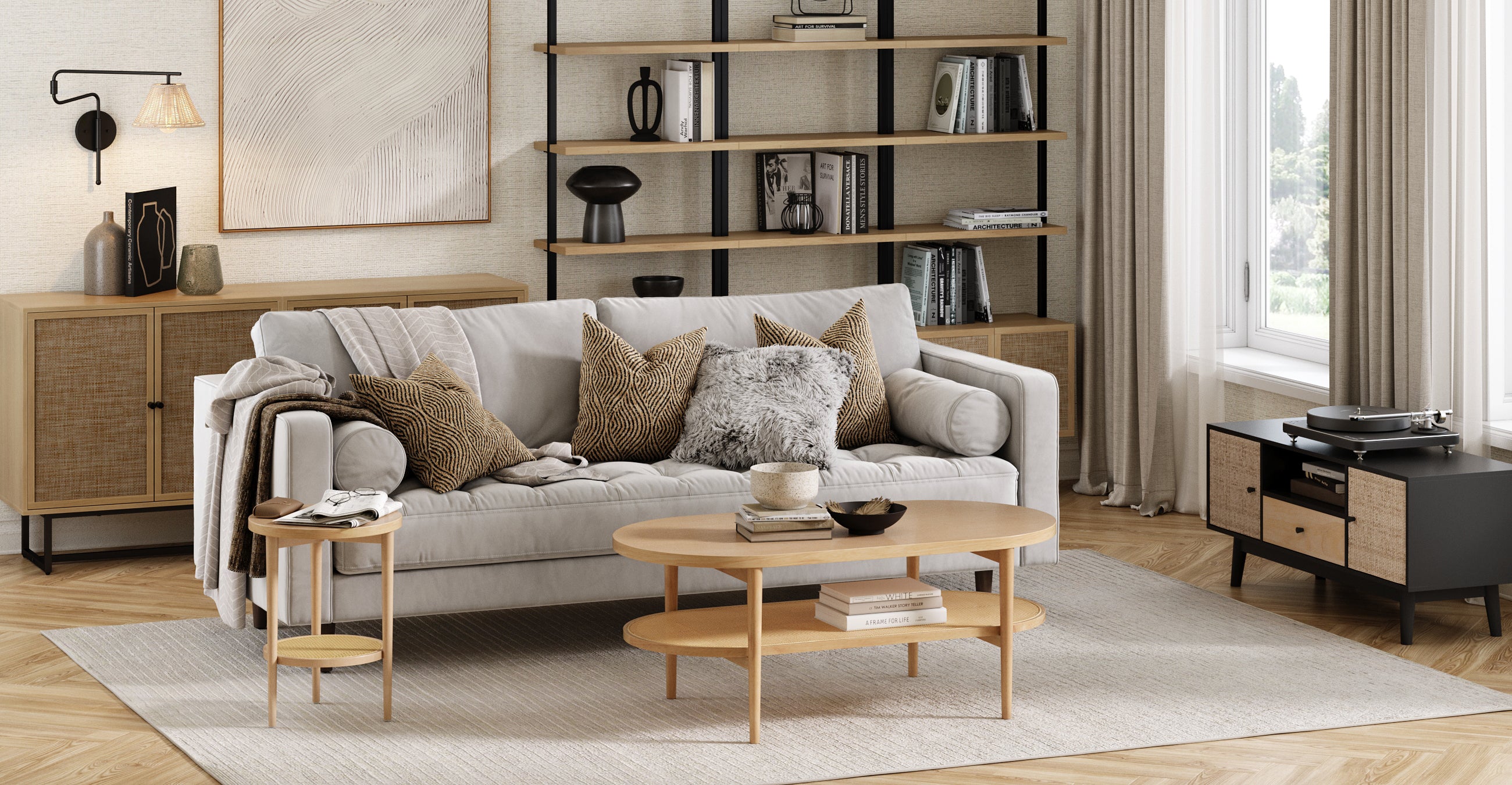 A modern living room with a light gray sofa, assorted neutral pillows, wooden coffee and side tables, a large rug, open shelves with decor, and a media console near a window with beige curtains.