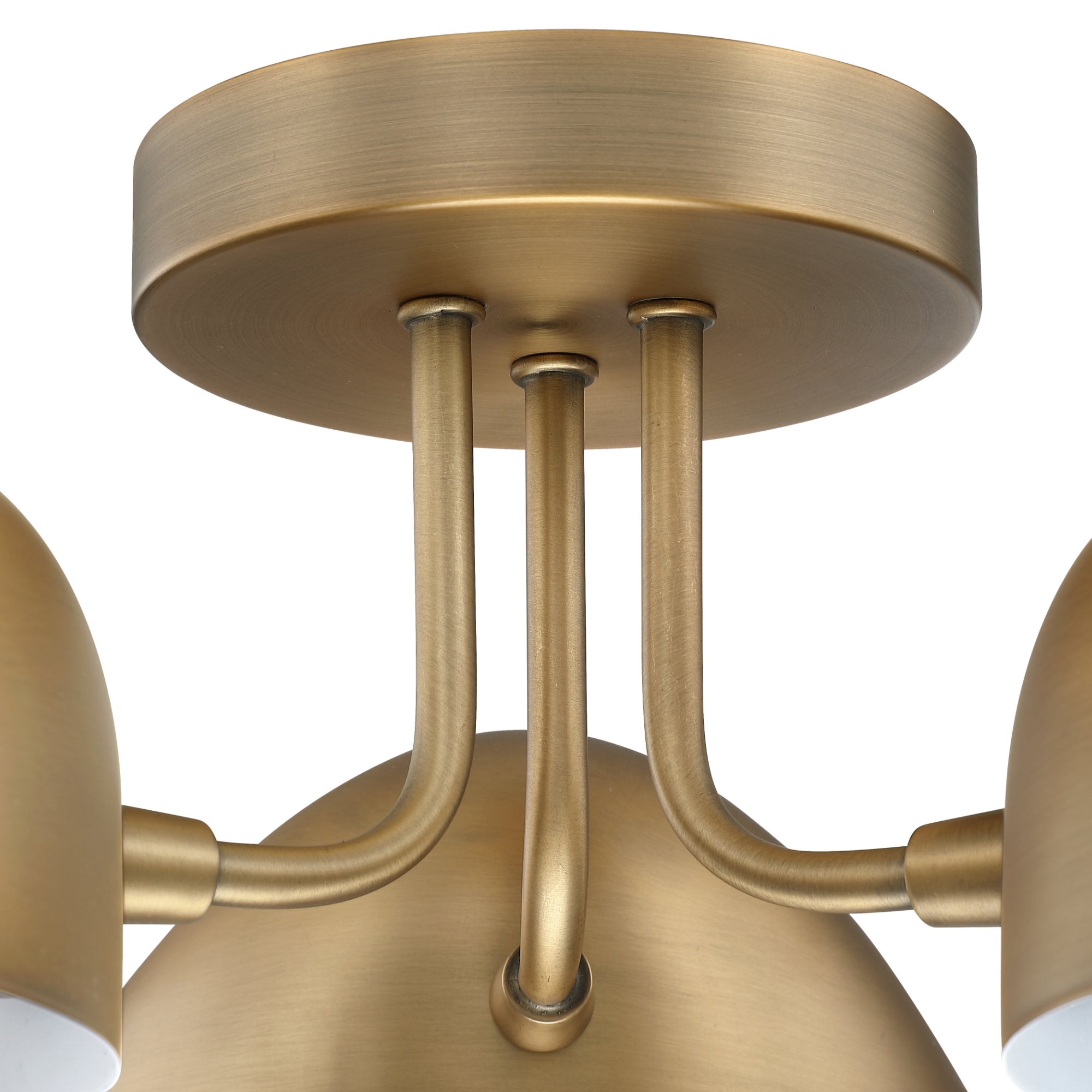 Close-up of a modern light fixture with a brushed brass finish, featuring round and cylindrical elements and three connecting rods attached to a circular ceiling mount.