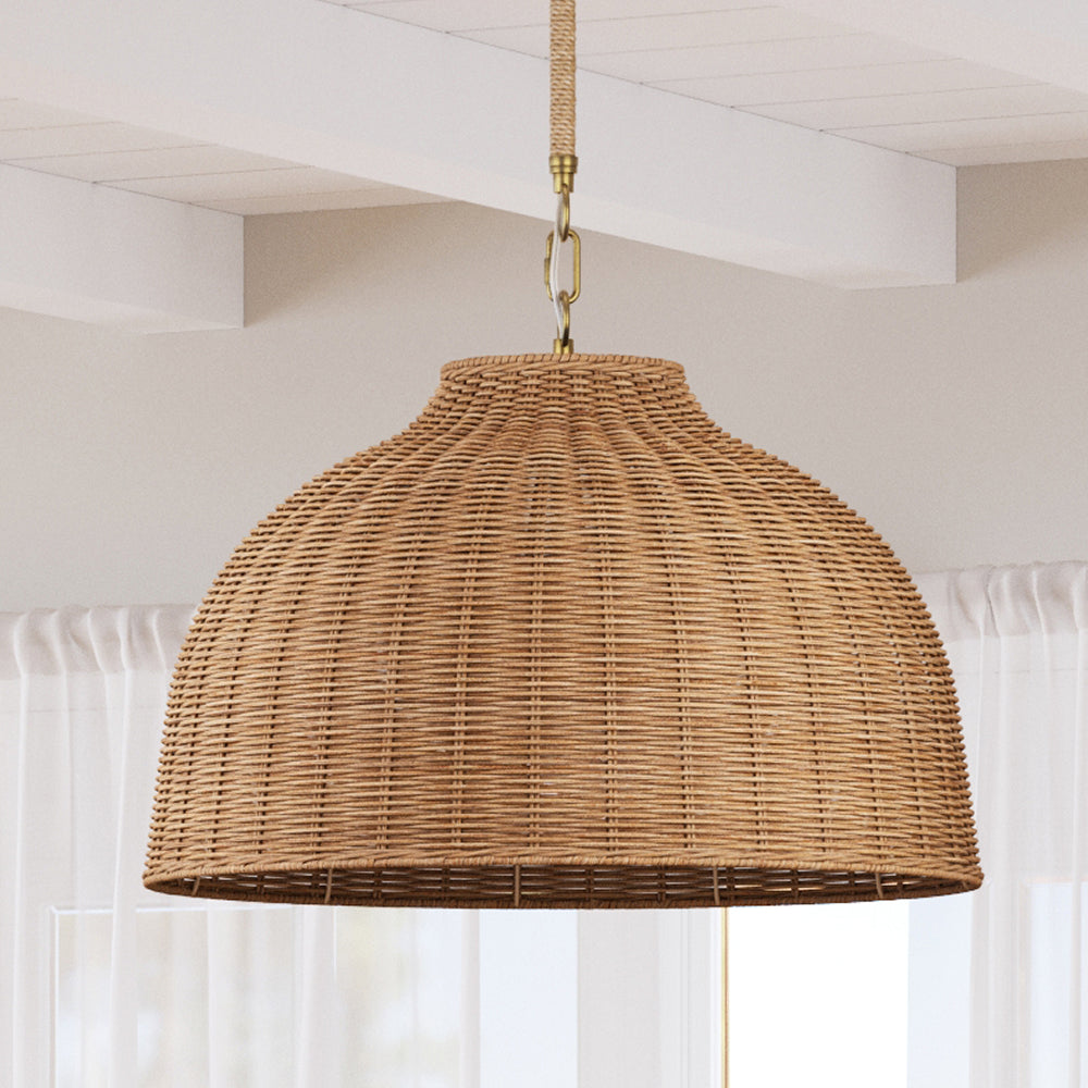 Dome-shaped woven rattan pendant light with a brass chain and natural cord suspension.