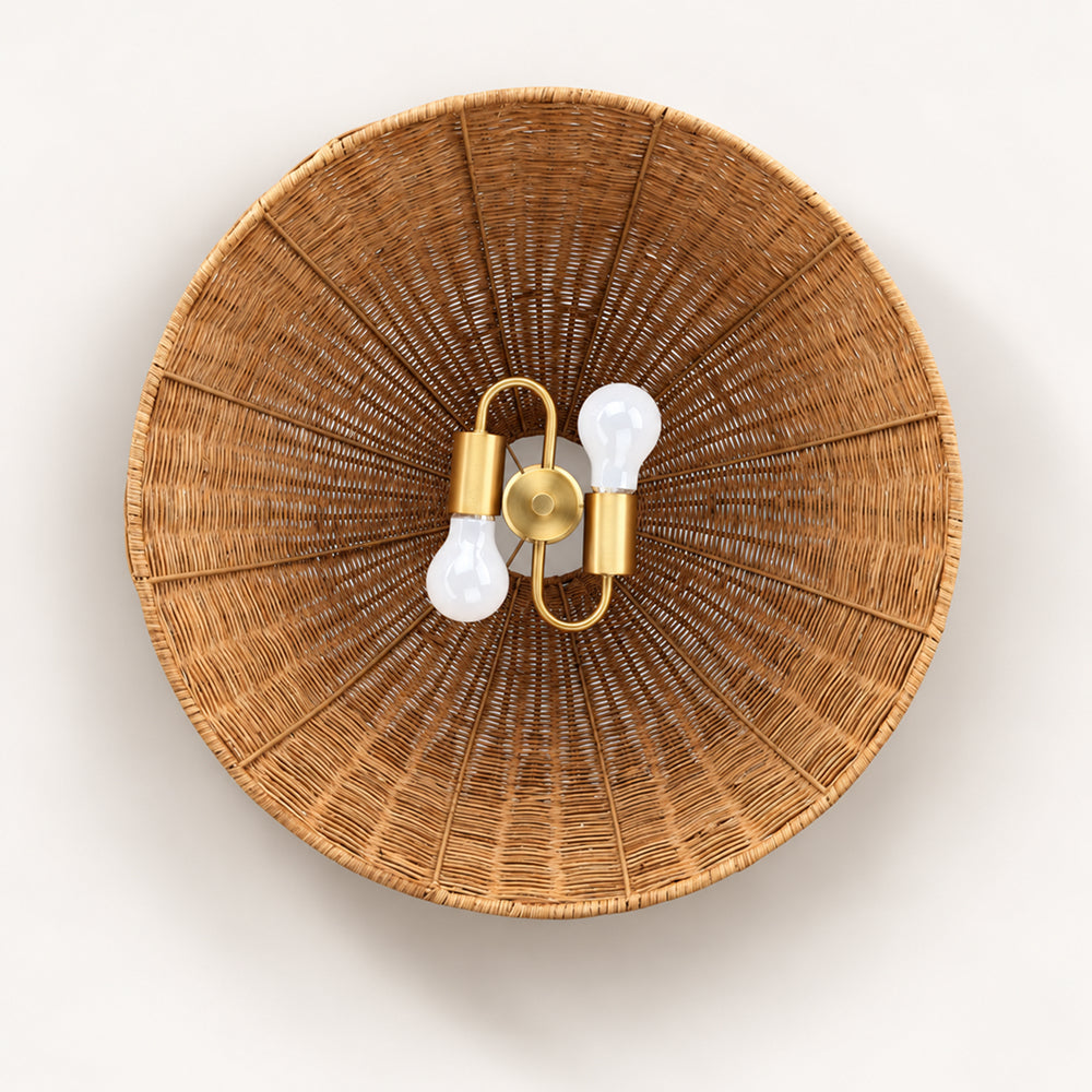 Round, woven rattan flush-mount ceiling light with a gold fixture and two exposed lightbulbs.