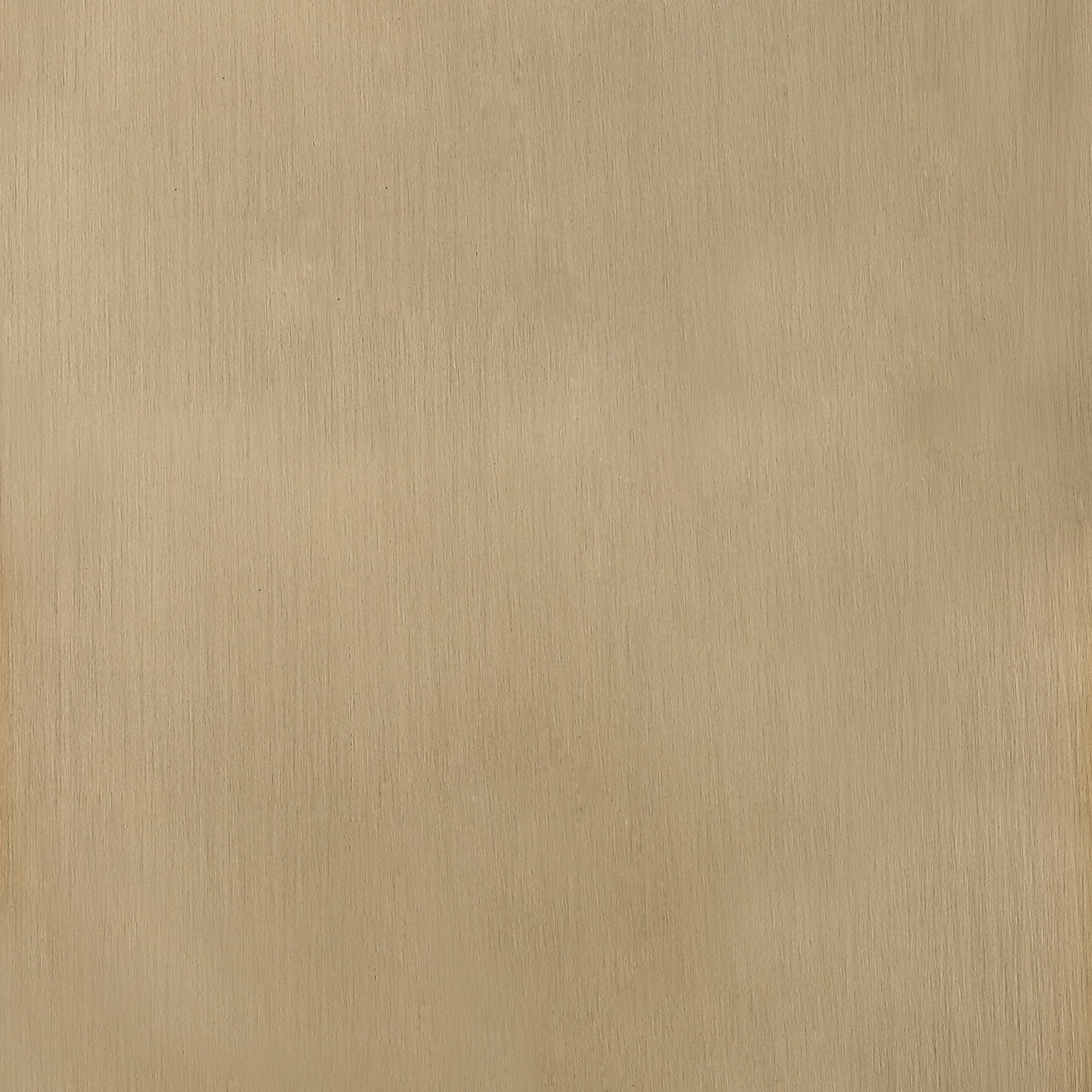 A close-up view of a brushed brass metal surface with a matte finish, showing subtle vertical lines and a warm golden-brown color.