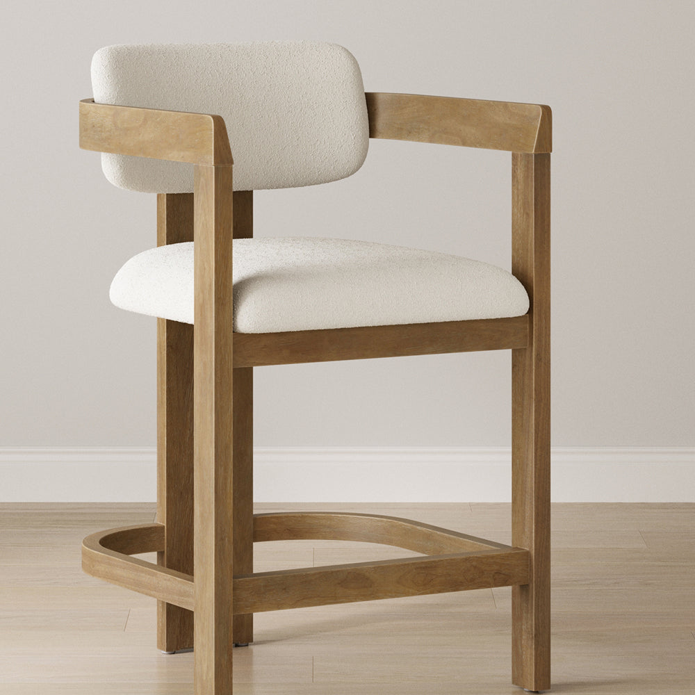 Counter stool with a wooden frame and cream-colored upholstered seat and backrest.