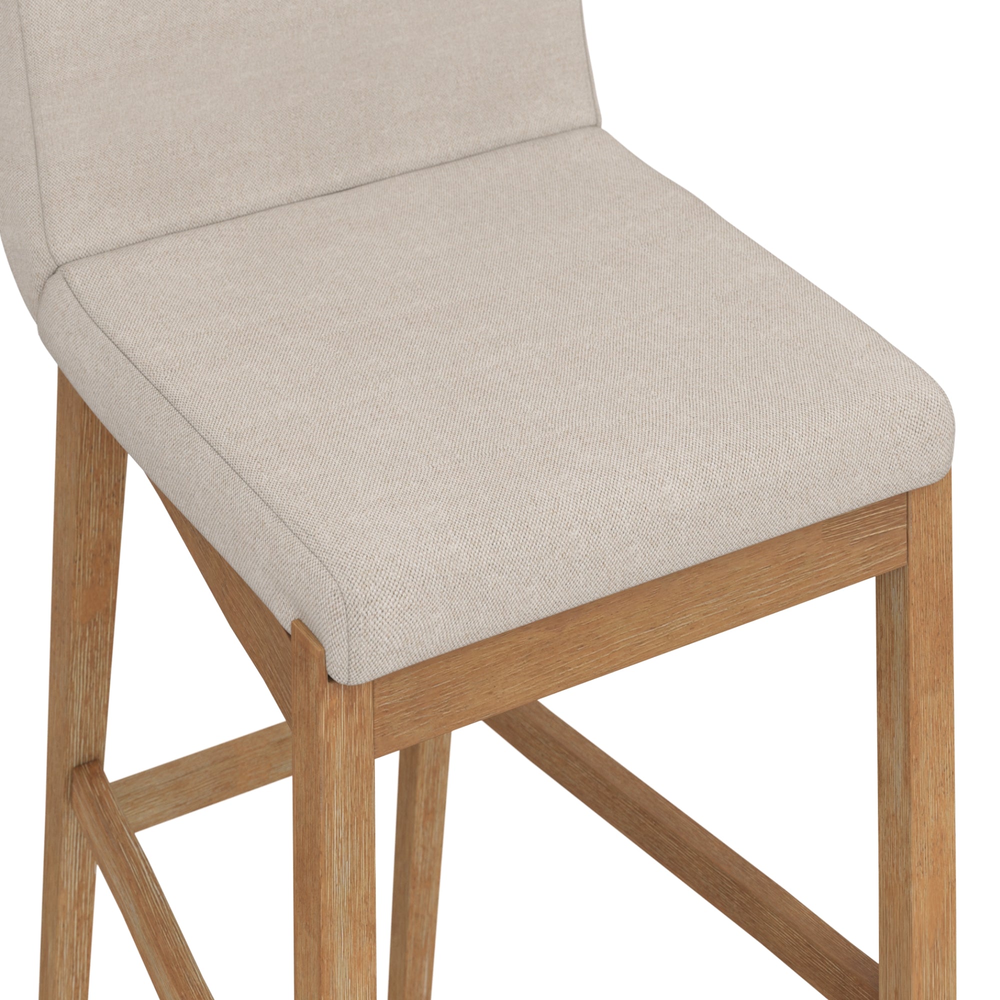 A close-up view of a bar stool with a light beige upholstered seat and backrest, supported by light-colored wooden legs and a crossbar footrest.