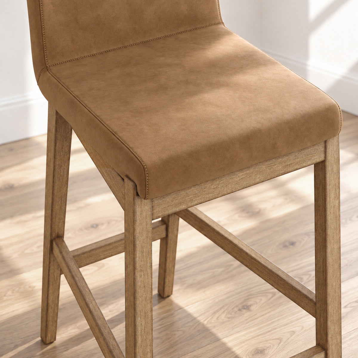 Brown upholstered bar stool with a wooden frame.