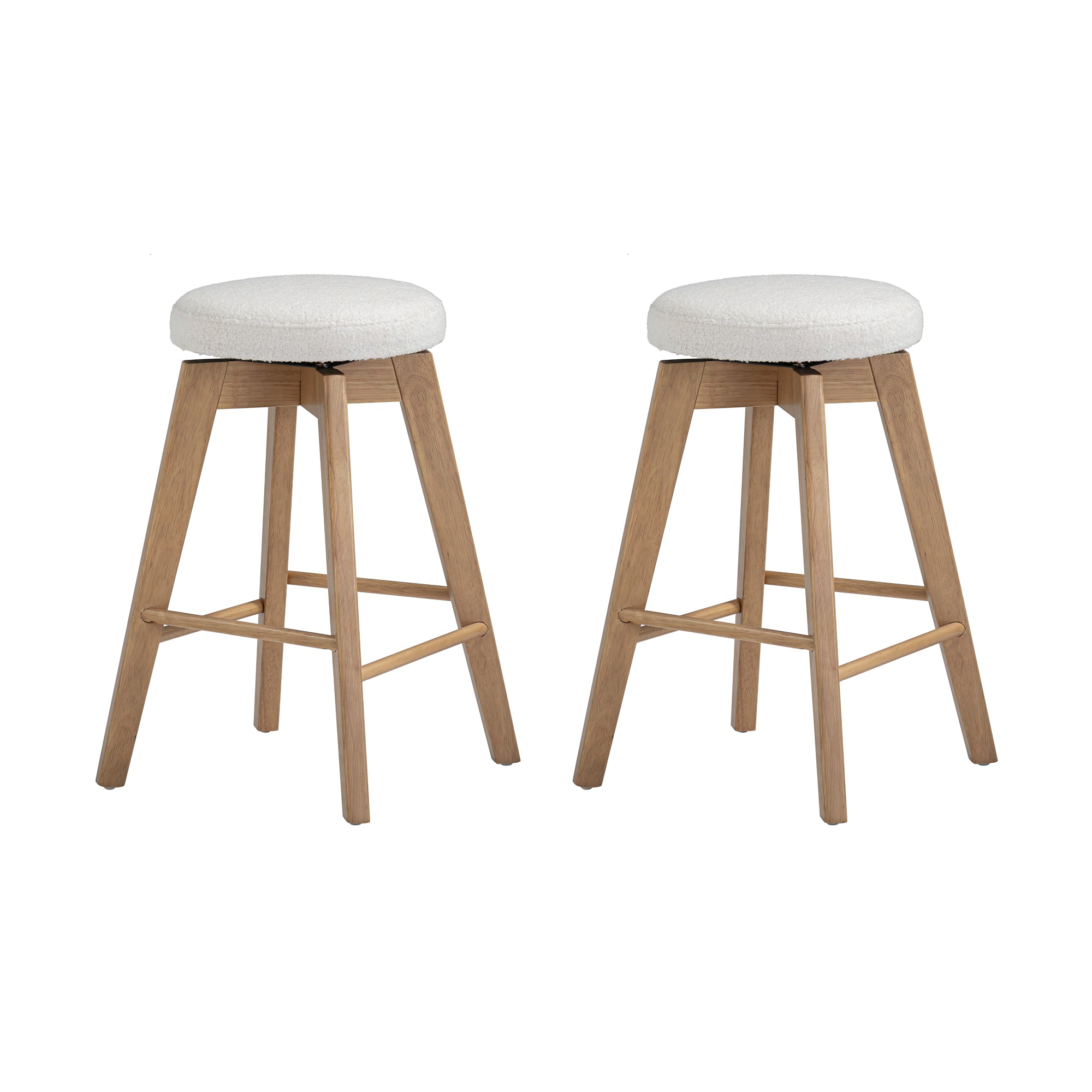 Two wooden barstools with four angled legs and footrests, featuring round, cushioned seats upholstered in a light-colored fabric. The stools are set against a plain white background.
