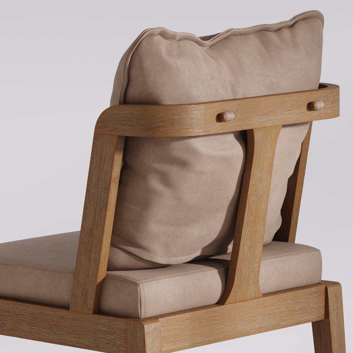 A wooden armchair with light-colored, soft cushions on the seat and backrest.