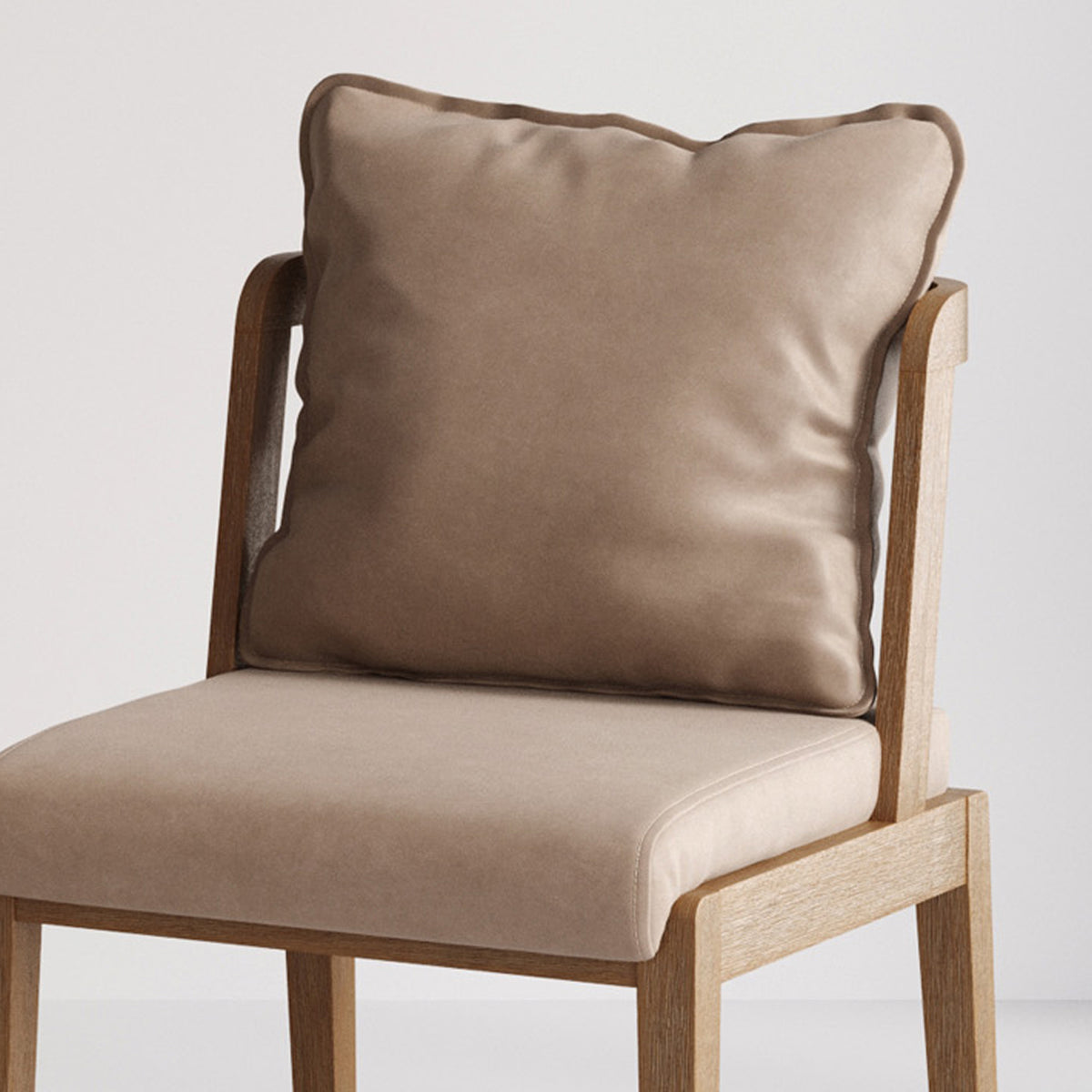 Wooden dining chair with a light beige upholstered seat and a matching square decorative pillow.