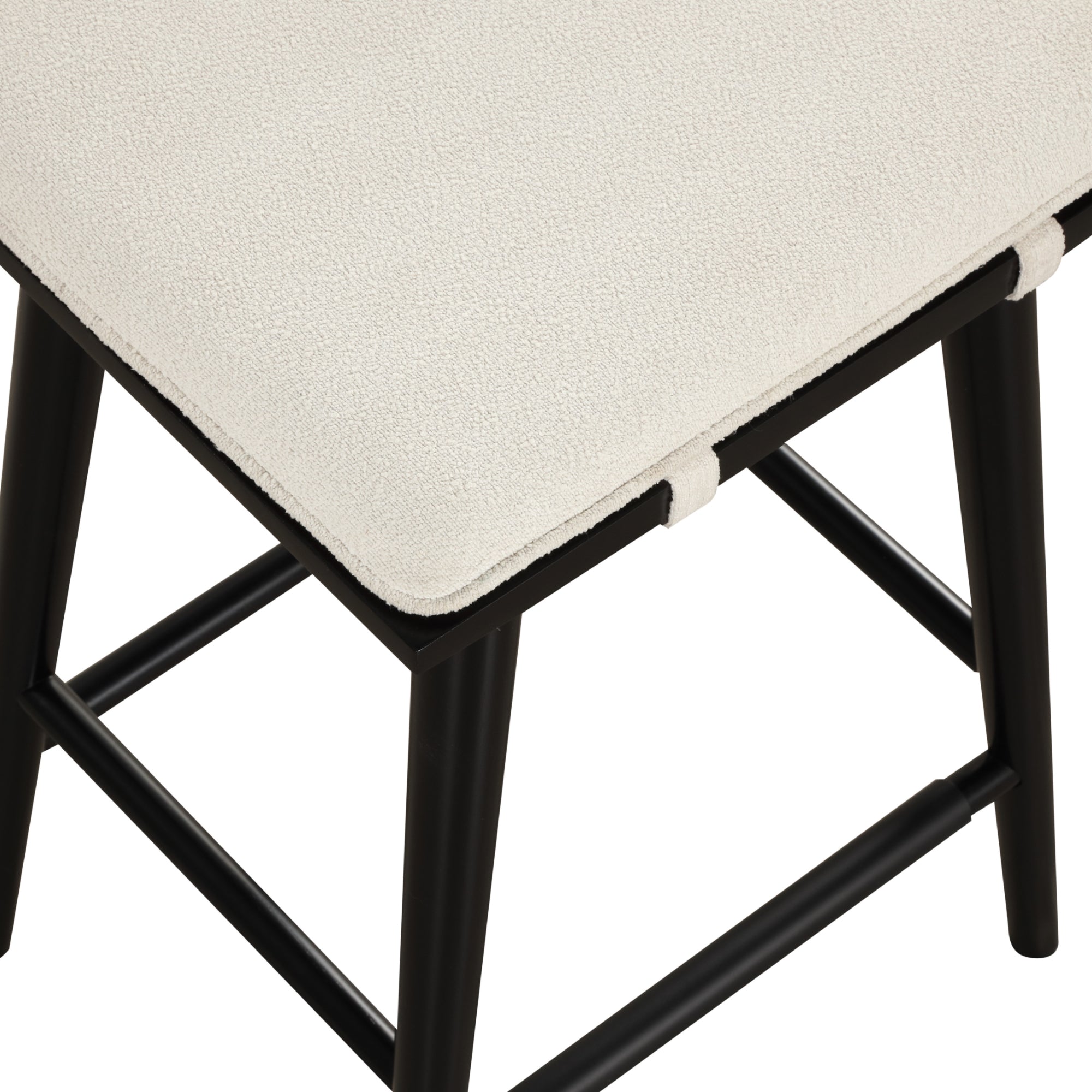 Close-up of a modern chair with a black wooden frame and a white textured cushion seat, showing the corner and part of the legs and support bars.