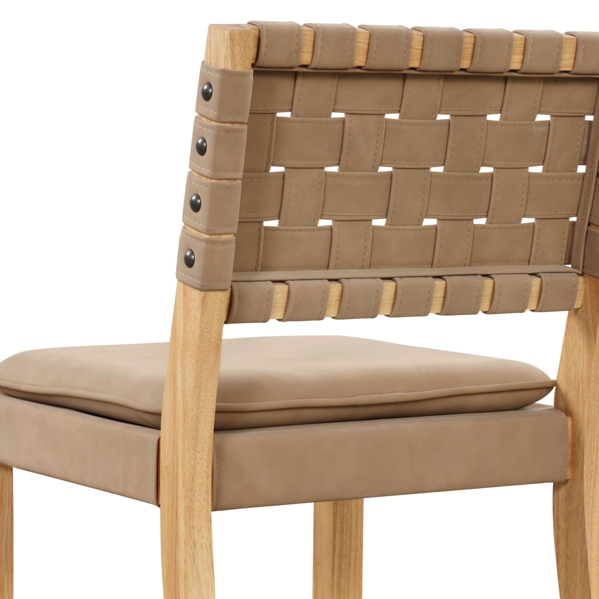 Close-up of a chair featuring a woven tan leather backrest, cushioned seat, and light wooden frame with metal rivets on the side for added detail.