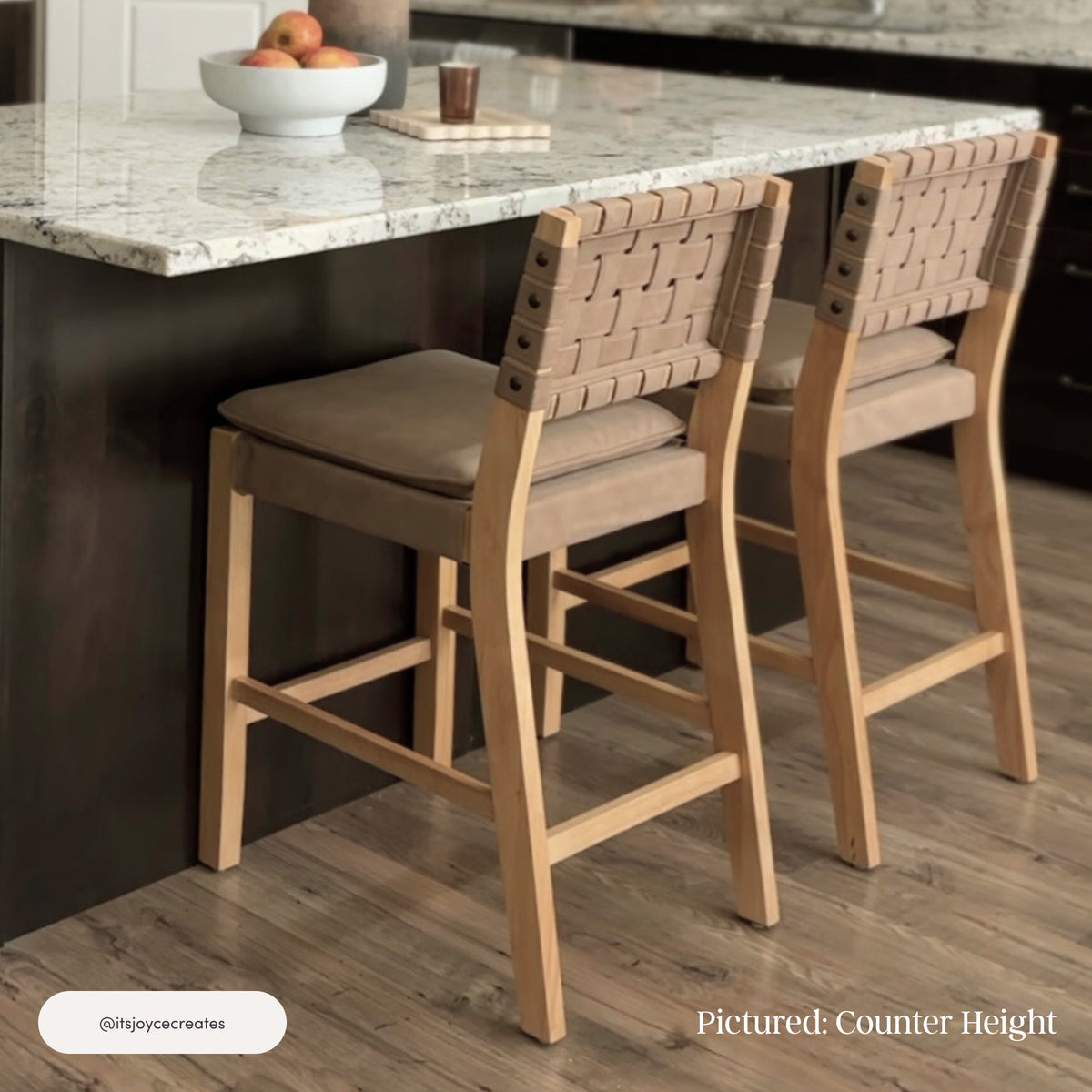 Two 29″ Nathan James Faux Suede Woven Bar Stool Brown units with padded seats and woven faux suede backrests positioned at a kitchen island.