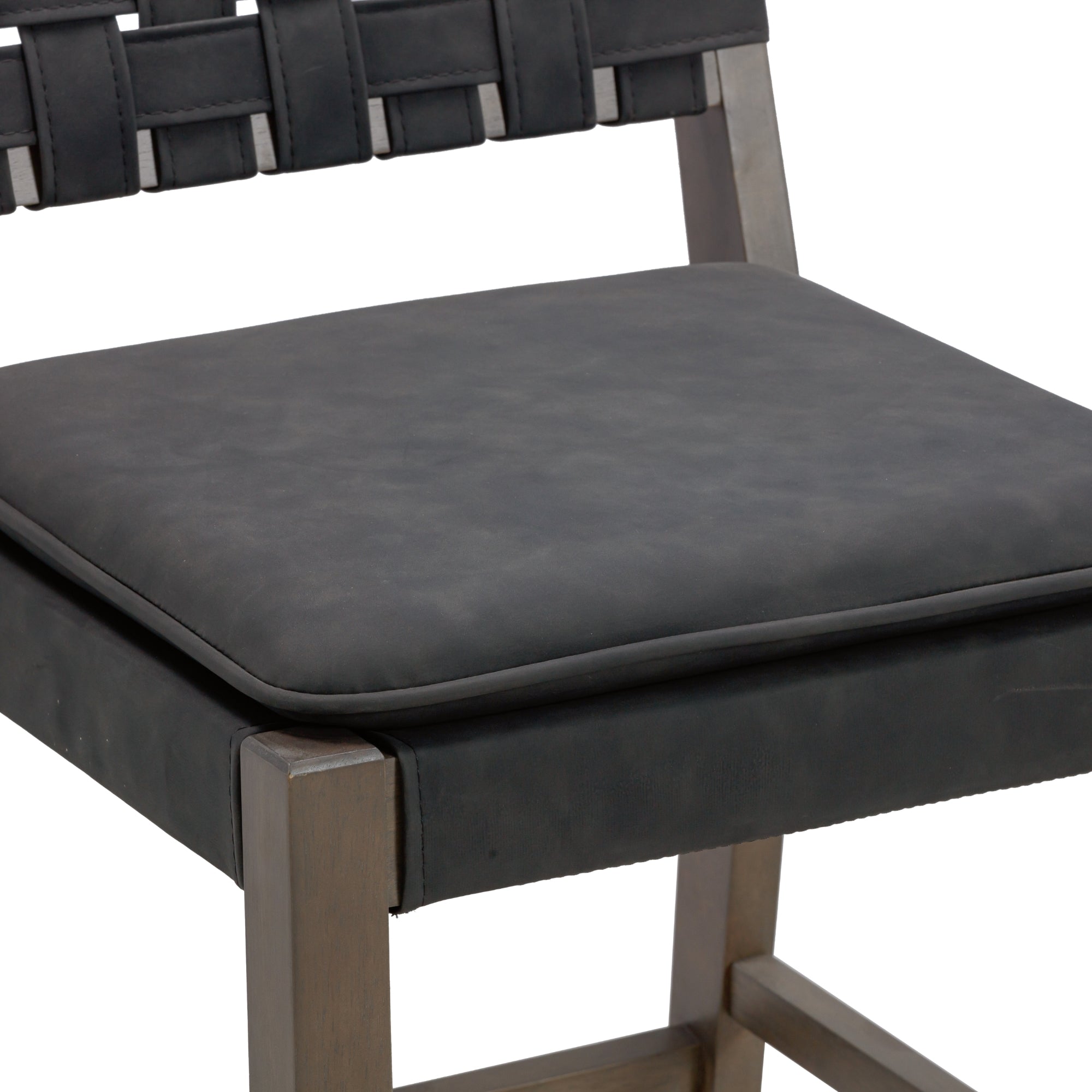 A close-up of a modern chair with a cushioned black seat and a woven black backrest, supported by a wooden frame with a dark finish.