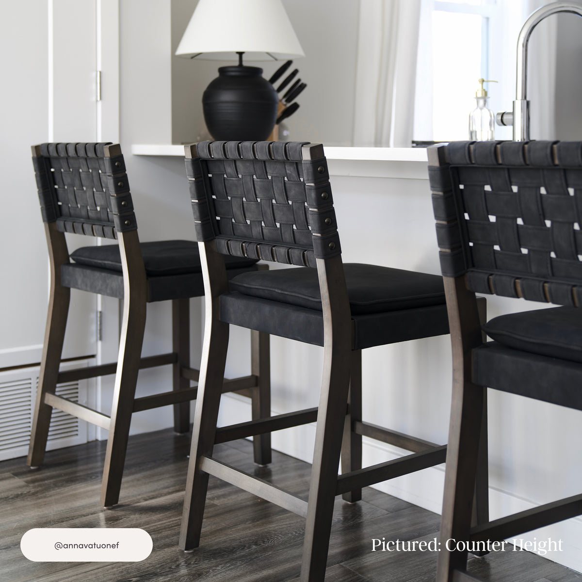 Three Nathan James Faux Suede Woven Bar Stools Black (Set of 3) with solid wood frames, woven backrests, and padded seats positioned at a kitchen counter.