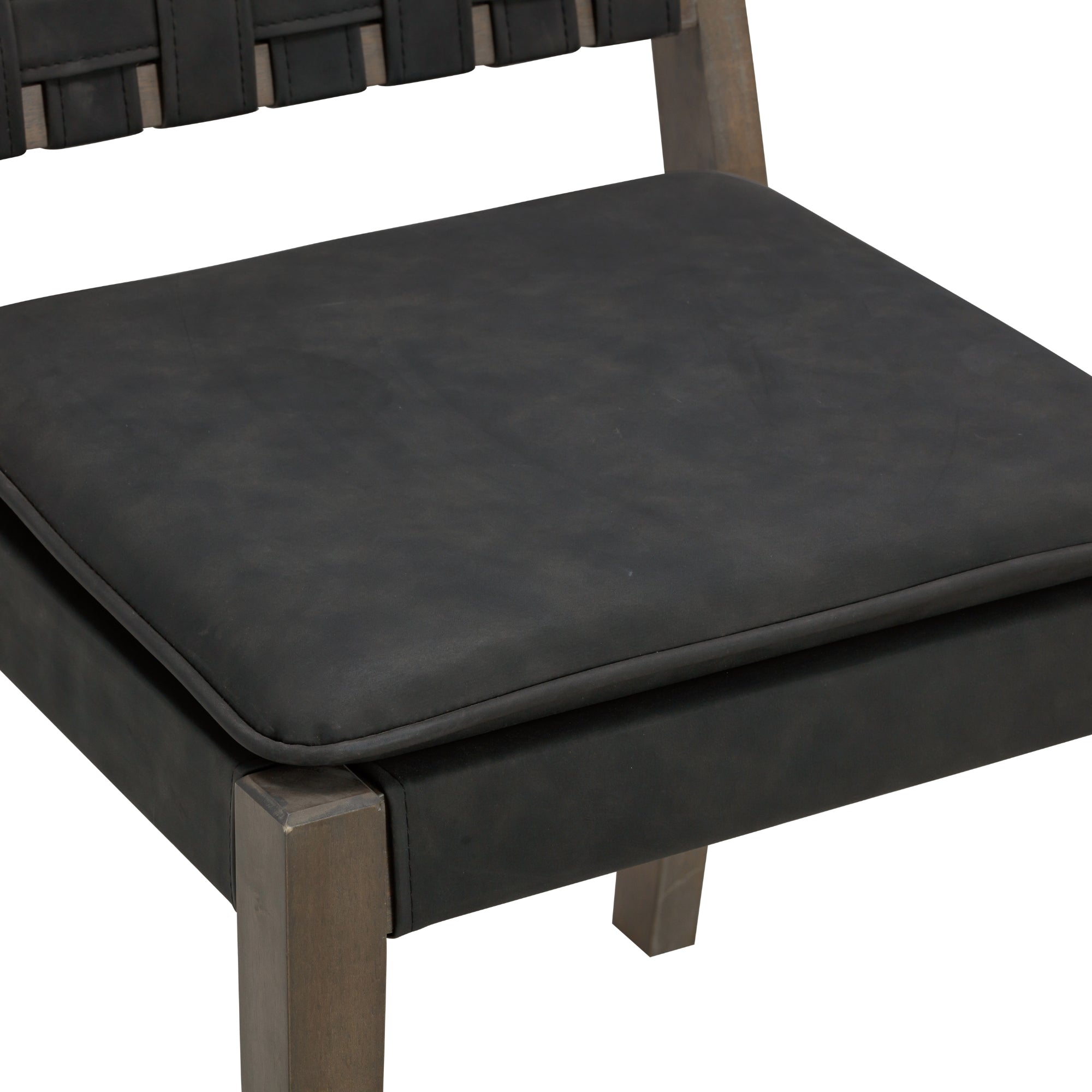 Close-up of a chair seat with a black cushion and wooden frame. The cushion appears smooth and slightly matte, and part of the woven black backrest and wooden legs are visible.