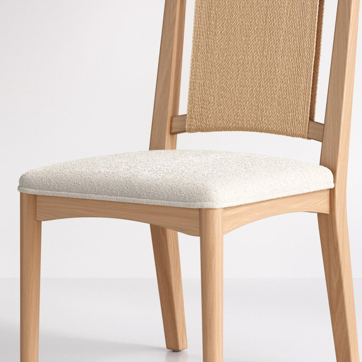 Light wood dining chair with a woven backrest and an off-white upholstered seat.