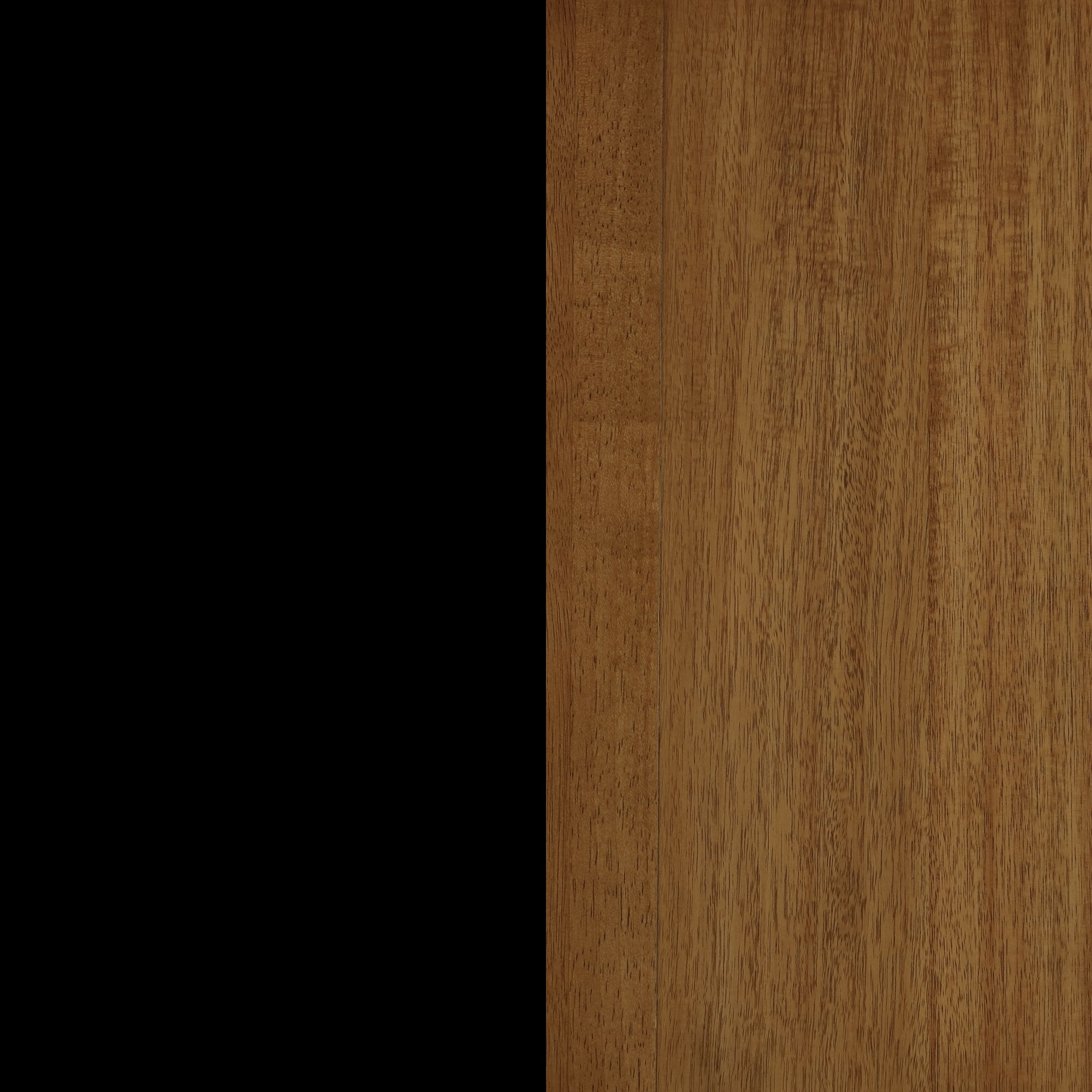 The image is split vertically; the left half is solid black, while the right half shows a medium brown wooden surface with visible grain patterns.