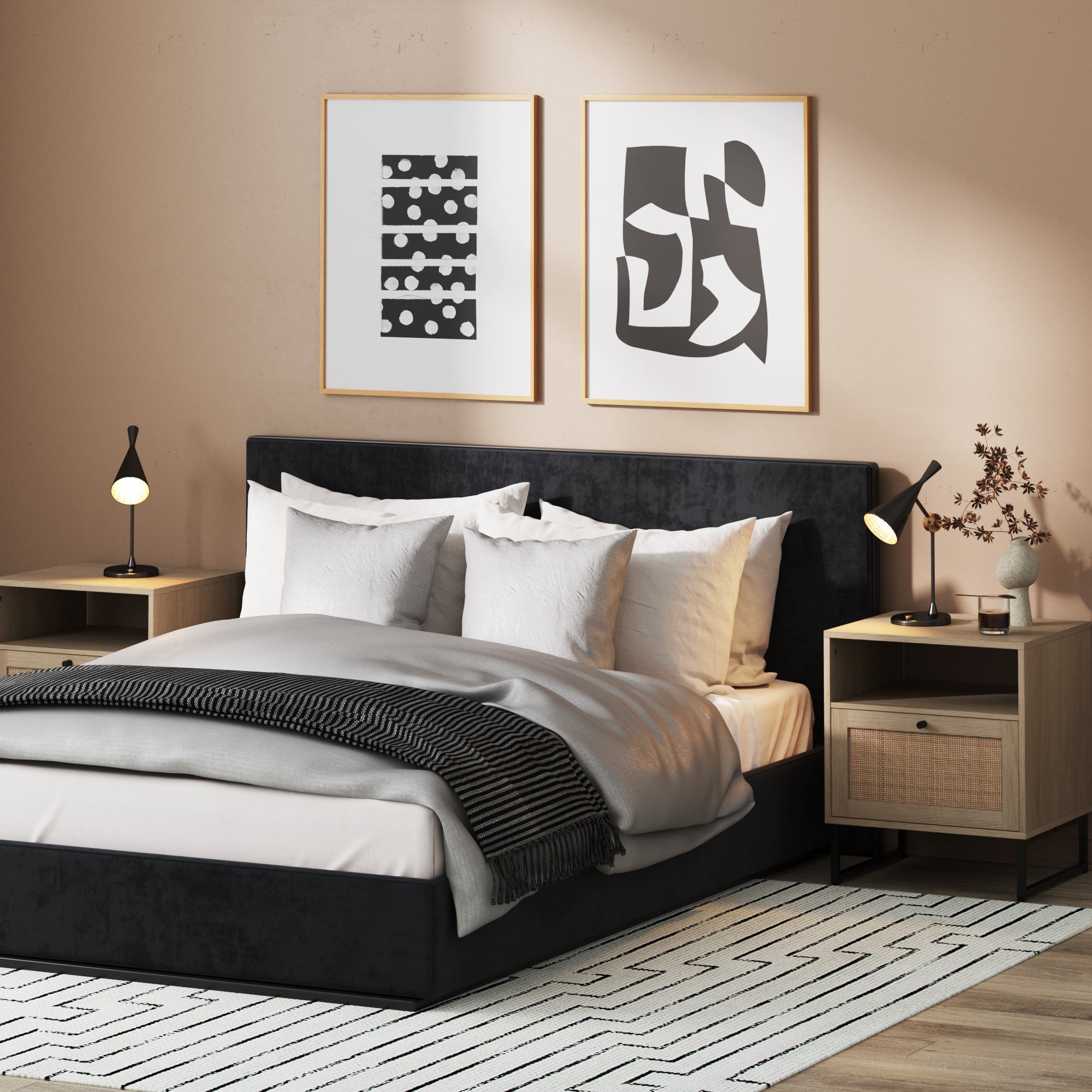 Modern bedroom with a black upholstered bed, white and gray bedding, two wooden nightstands with lamps, abstract art above the bed, and a patterned rug on the floor. Dried branches in a vase sit on the right nightstand.