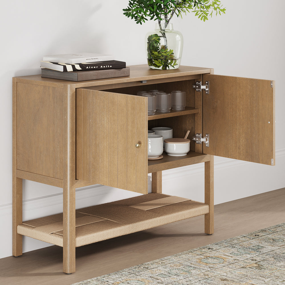 A wooden cabinet with open doors revealing interior shelves containing bowls and glasses, with books and a vase on top.