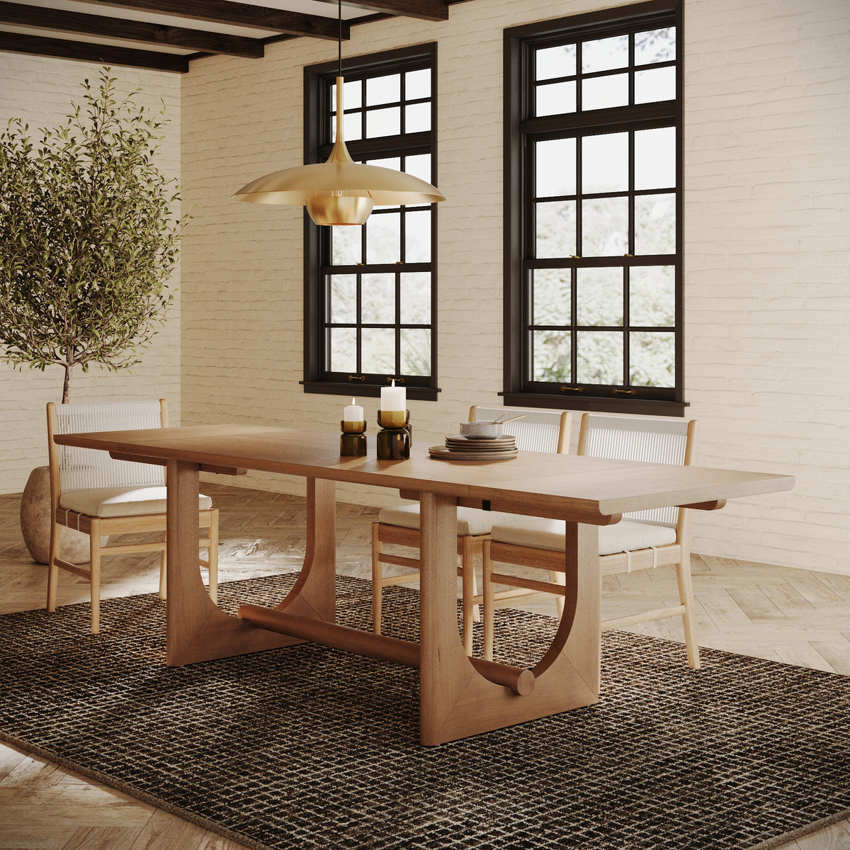 A Nathan James Wood Extendable Dining Table with Leaf Extensions for 8, featuring a unique curved base and extension leaves, surrounded by four light-colored chairs in a dining room.