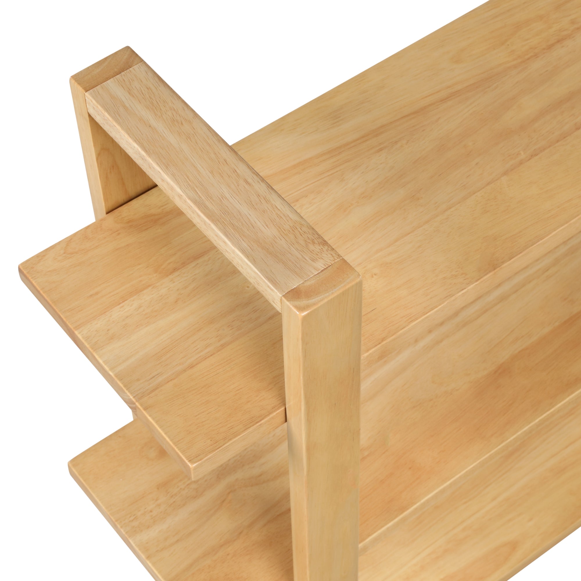 A close-up view of a light wood rectangular table with minimalist design, featuring clean lines and a small shelf underneath the tabletop.