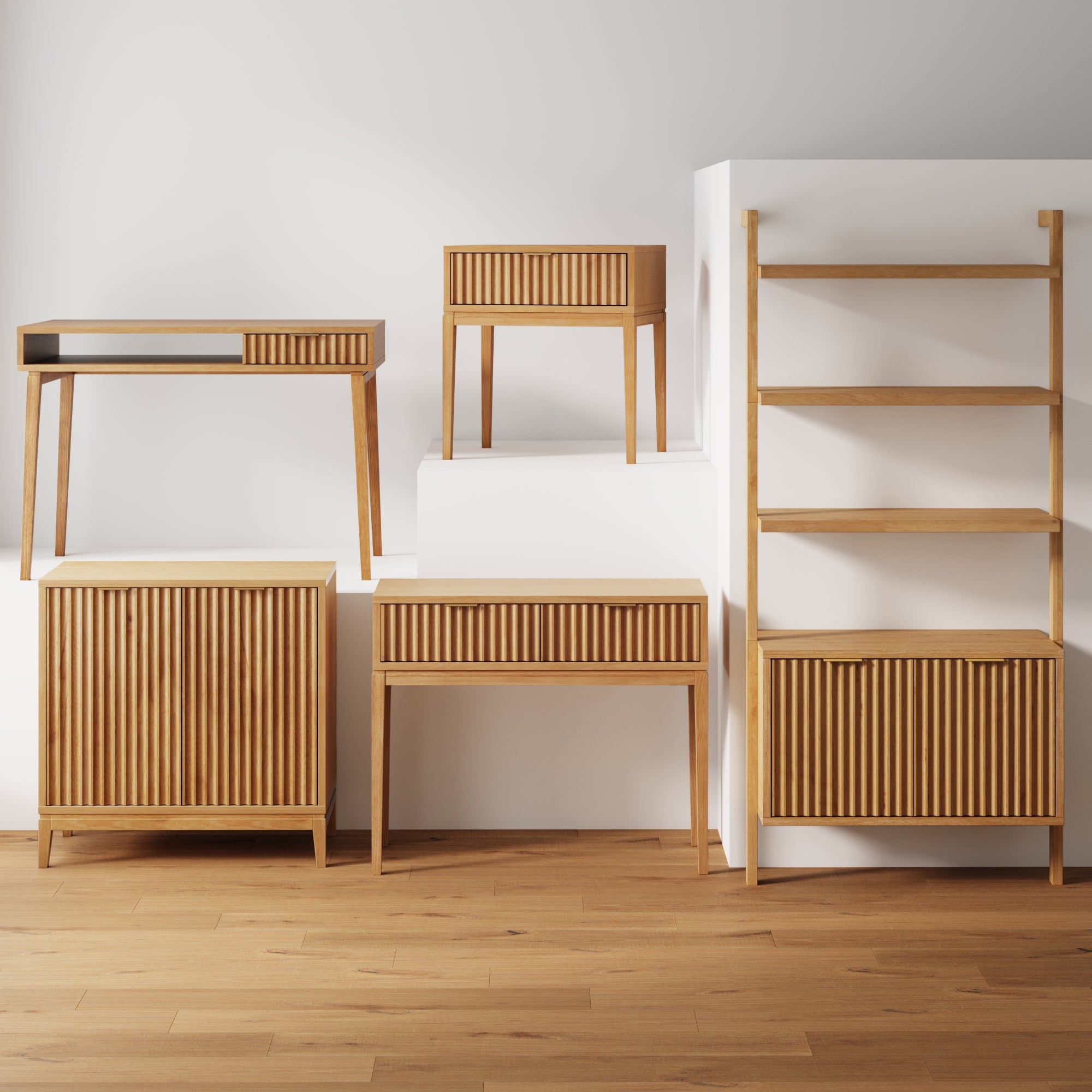 A collection of modern wooden furniture including a desk, side table, cabinet, console, and a shelving unit, all with vertical slatted fronts, displayed on a wooden floor against a white wall.