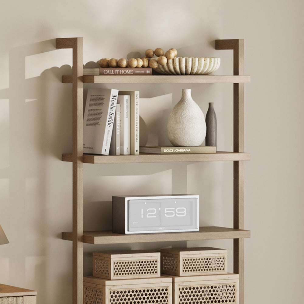 A four-shelf wooden wall unit displaying books, decorative bowls, vases, a digital clock reading 12:59, and woven boxes.