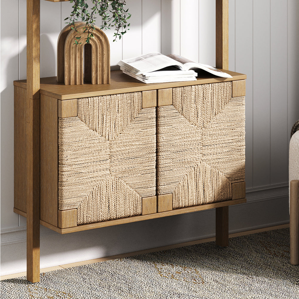 Wood storage cabinet with two doors featuring a woven rope geometric pattern, topped with a decorative arch and an open book.