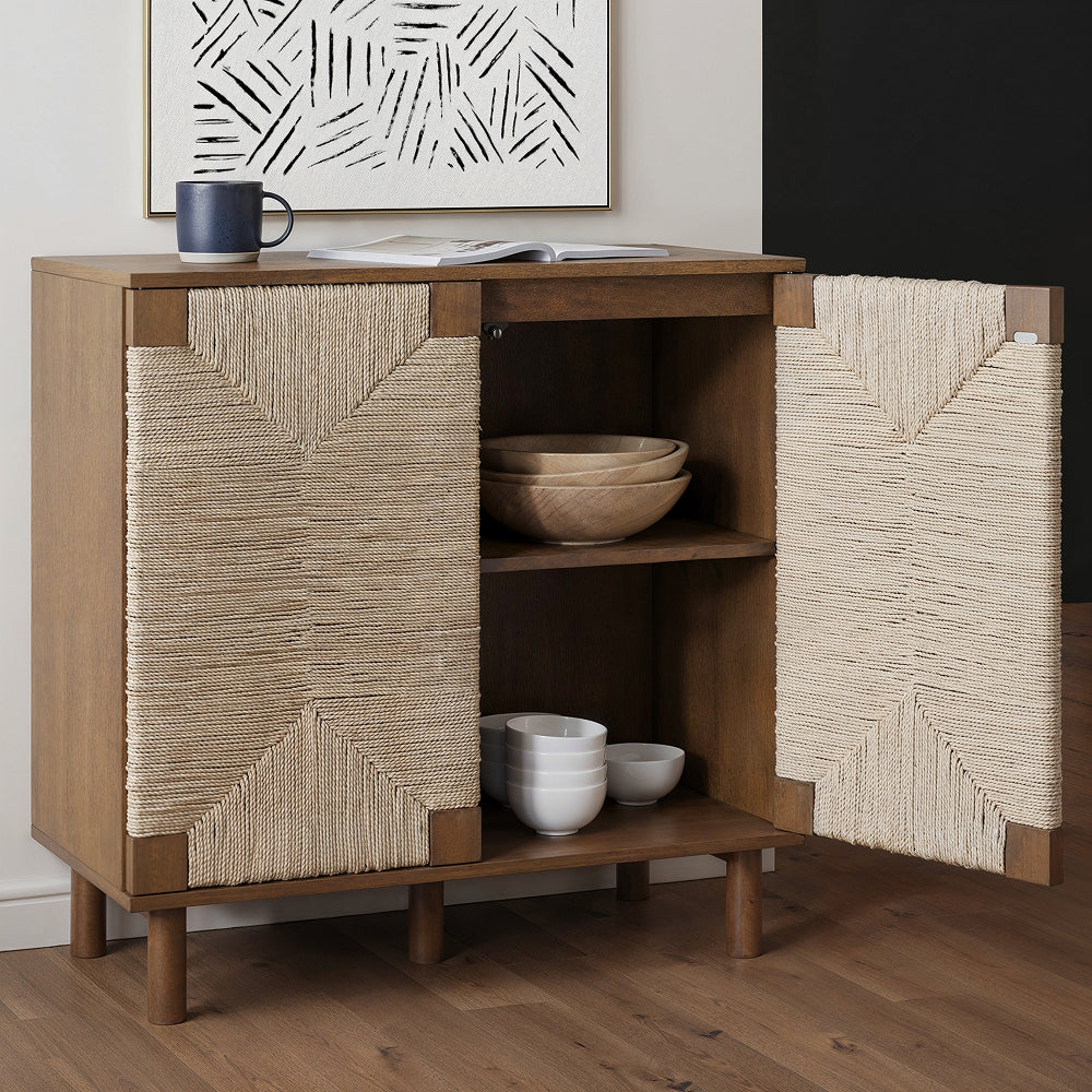 Wood cabinet with two doors wrapped in light-colored rope, with one door open to reveal bowls on internal shelves.