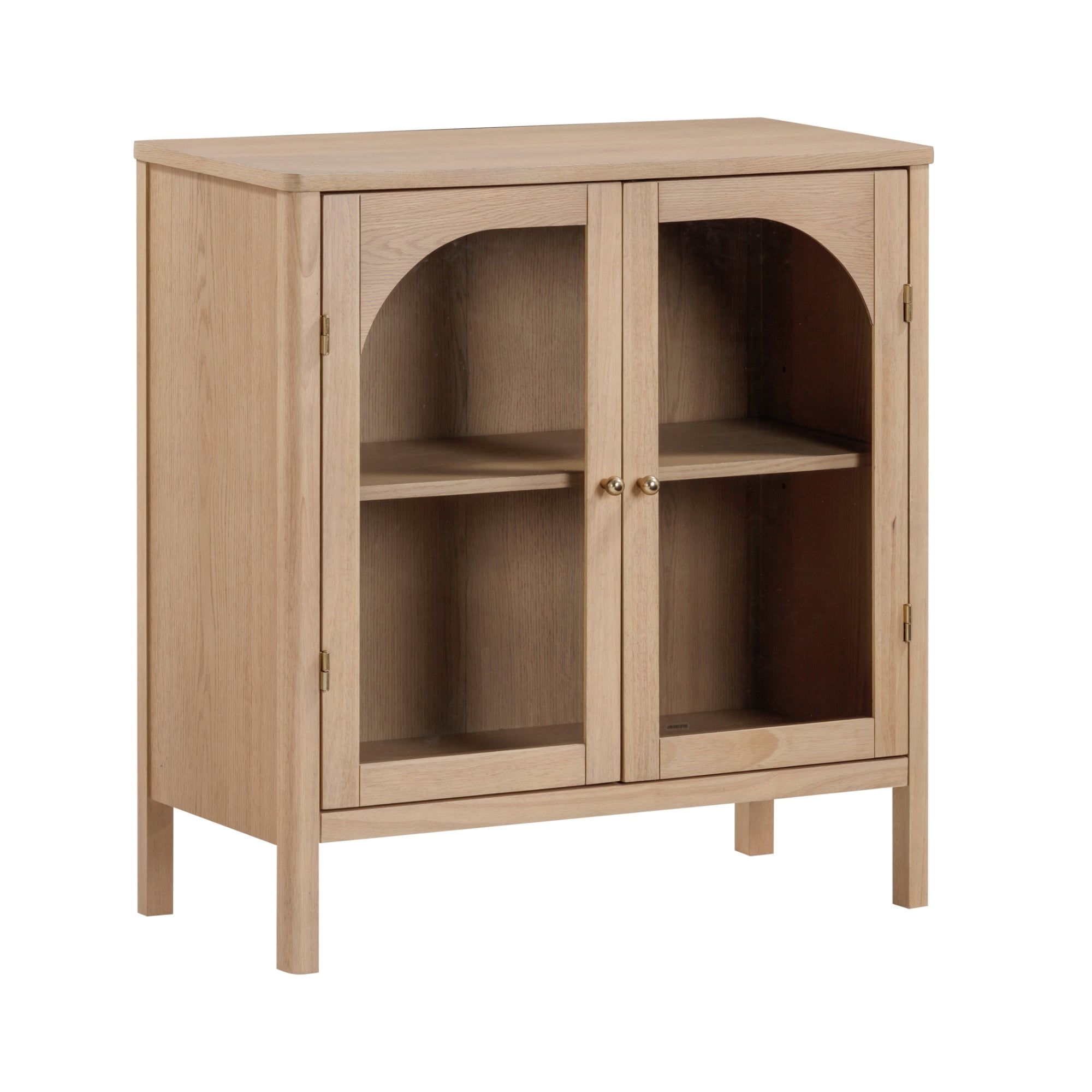 Light wood display cabinet with two glass doors, gold knobs, and an interior shelf, standing on four legs. The cabinet has a simple, modern design with arched glass panel detailing on the doors.
