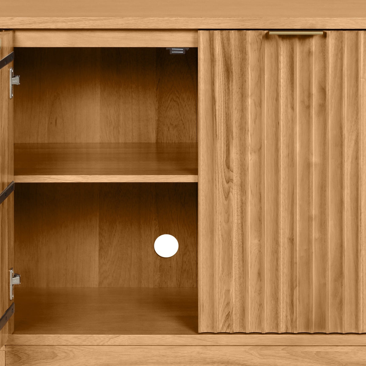 Light wood cabinet with one open shelf and one closed ribbed door featuring a brass handle.