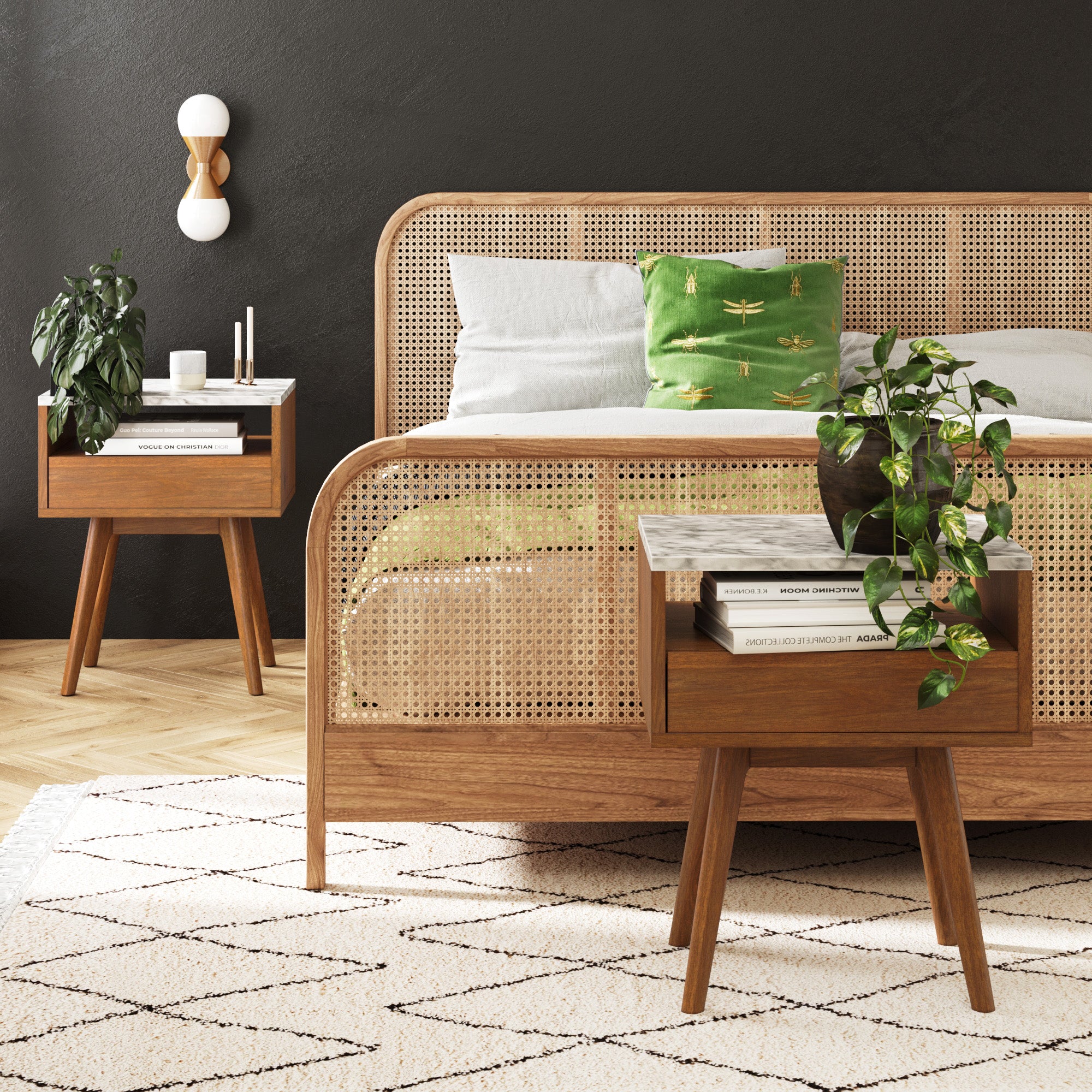 A modern bedroom with a cane bed frame, white and green bedding with dragonfly prints, two wooden nightstands holding books, plants, and decor, and a geometric-patterned rug on a light wood floor.