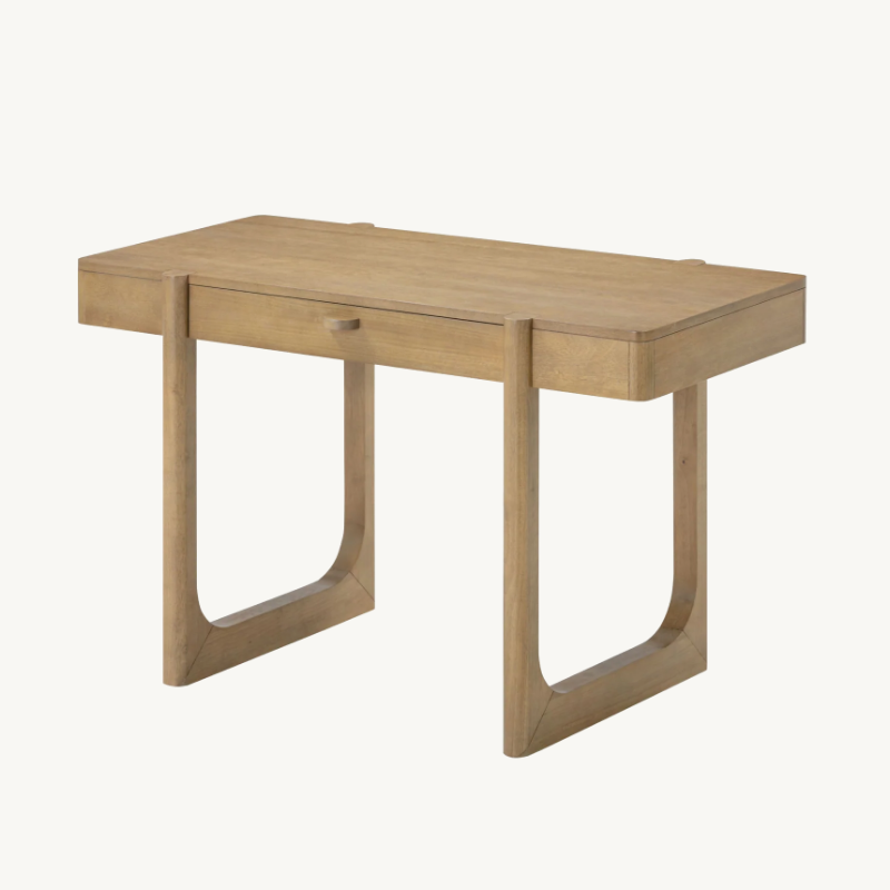 A light-toned wooden writing desk with a single drawer and U-shaped legs.