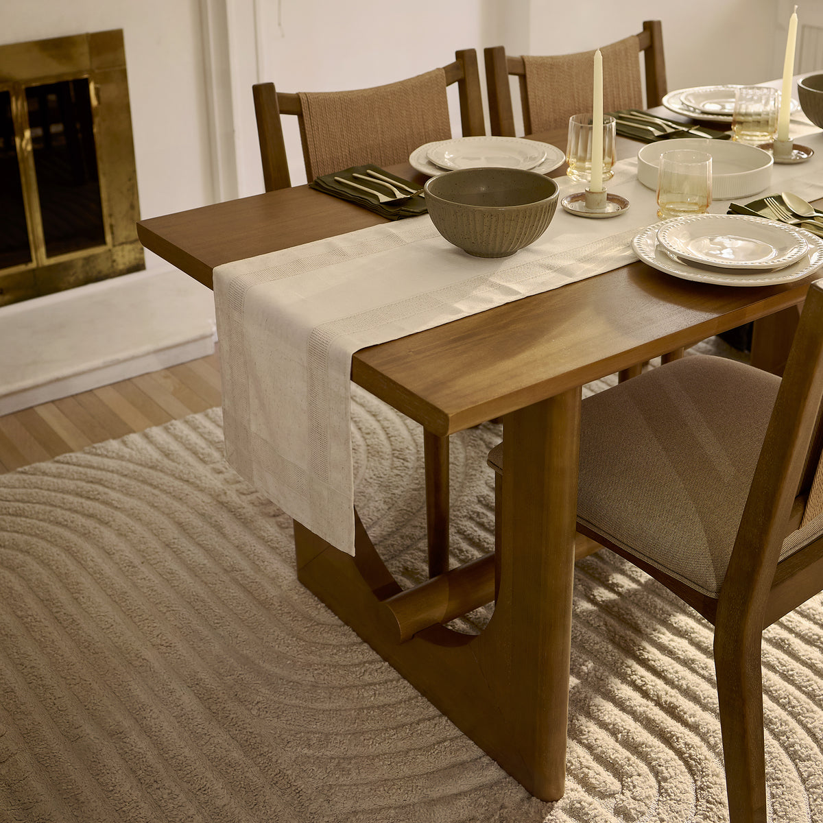 Mid-Century Extendable Wood Dining Table for 6 Light Brown set with six place settings, a table runner, and two candles.