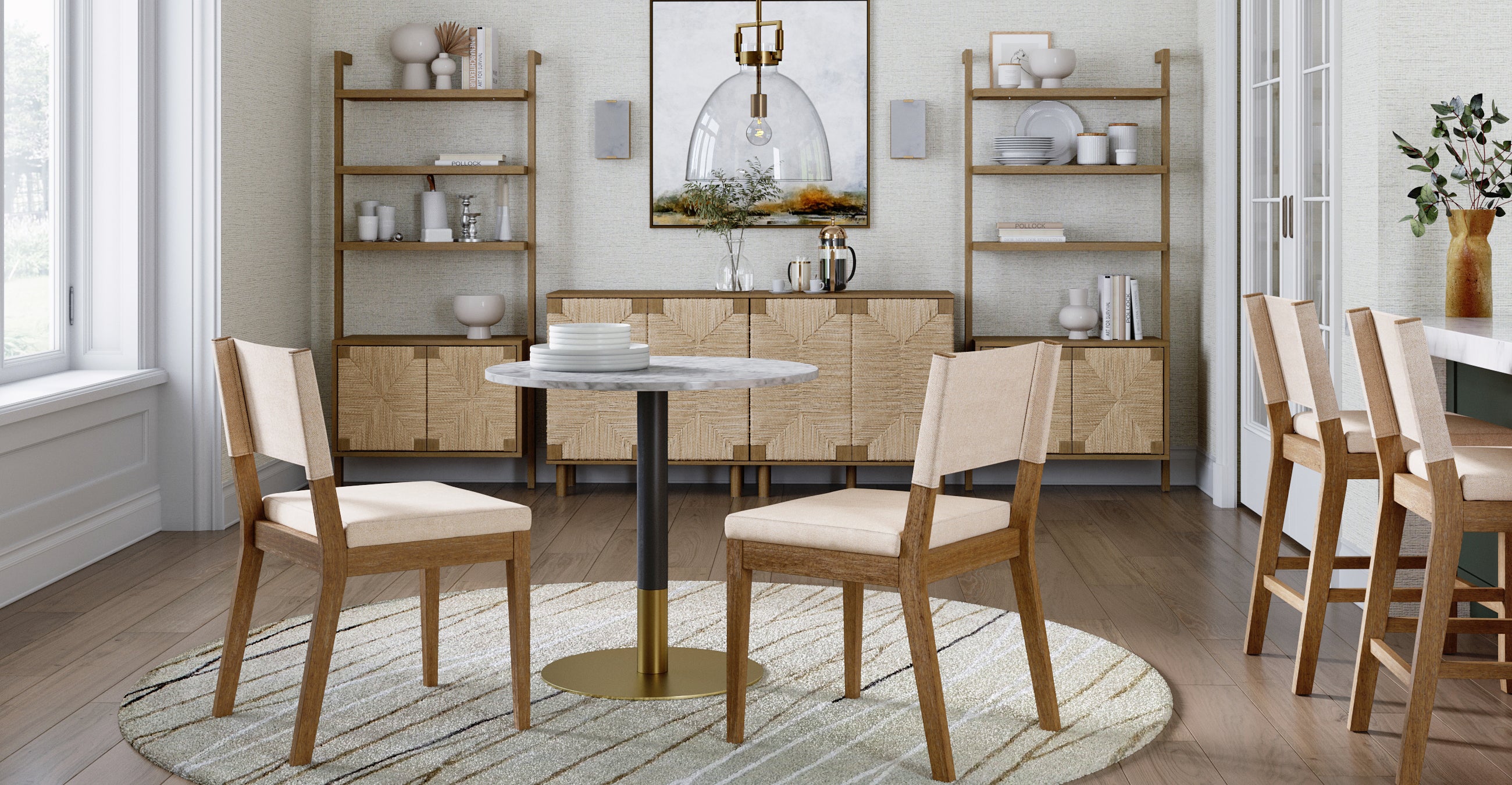A modern dining room with a round marble table, two wooden chairs with beige cushions, a patterned rug, light wood floors, and open shelves holding dishes and decor. A sideboard and framed art are against the back wall.